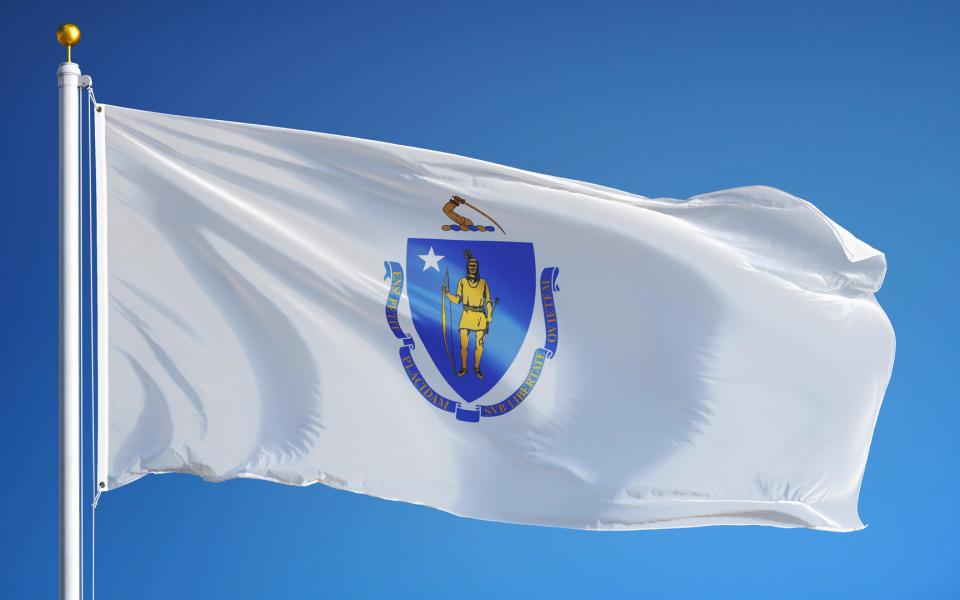 The Massachusetts State Flag waving in the sky.