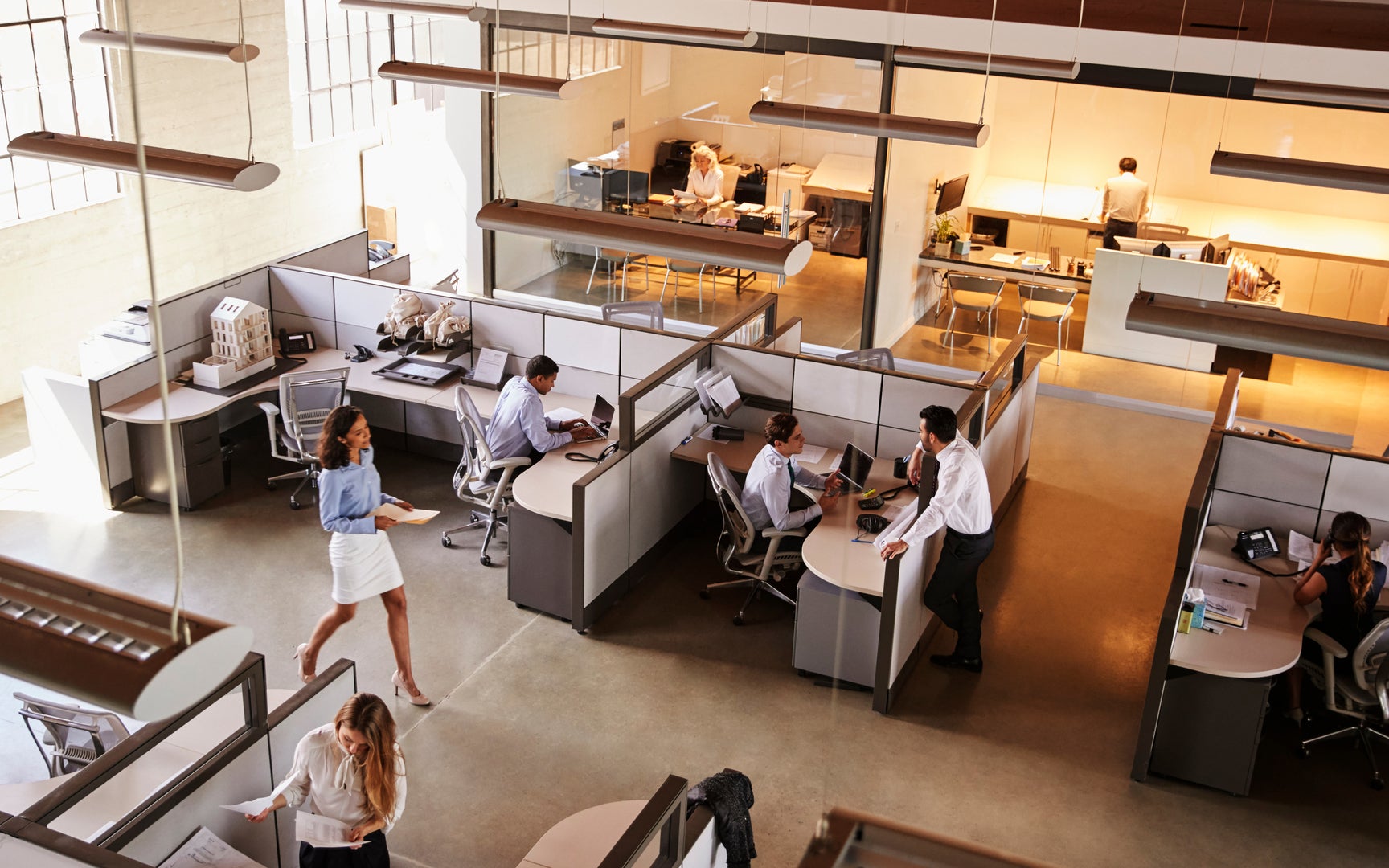 Elevated view of a busy office with cubicles.