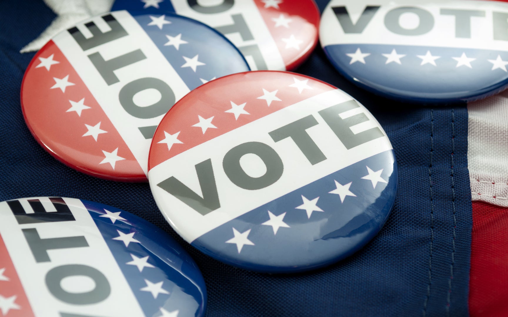 Close-up of American election red, white and blue "Vote" buttons.